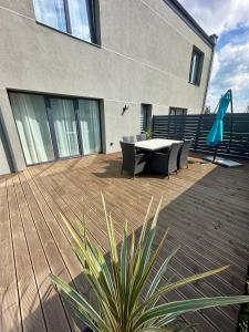 a patio with a table and chairs and an umbrella at Raudondvaris holiday home in Raudondvaris