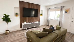 a living room with a couch and a flat screen tv at Cozy Private Triple Room in Design District Miami in Miami