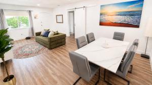 a dining room with a table and a couch at Cozy Private Triple Room in Design District Miami in Miami