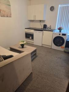a kitchen with a sink and a washing machine at Elegant 1-BR Flat with Free Private Parking, Kitchen & Wi-Fi in Middlesbrough