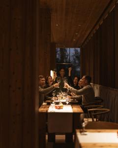 a group of people sitting at a table with wine glasses at Lakes Places Villas in Kyiv