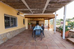 a patio with a table and chairs on it at Villa Paula in Benissa