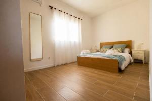 a bedroom with a bed and a large window at Villa Paula in Benissa +23 photos