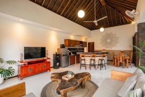 a living room with a couch and a tv at Villa Lapiz Lazuli - Seminyak Kuta Luxury Private Pool Villas in Seminyak