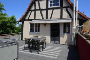 a patio with a table and chairs on a house at Ferienwohnung Camino in Jockgrim