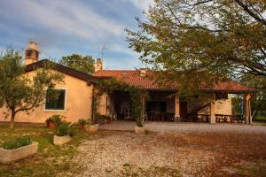 a large house with a patio in front of it at Agriturismo Hermada in Duino