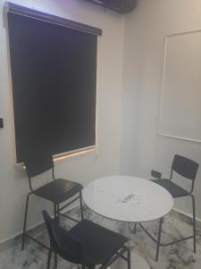 a meeting room with a table and chairs and a screen at Jasper luxury homes in Abuja +2 photos