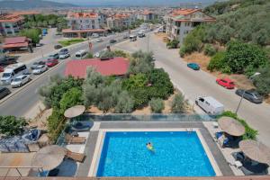 a swimming pool in the middle of a city at Kampüs Garden in Fethiye