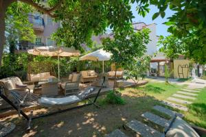 a playground with a slide and chairs and umbrellas at Kampüs Garden in Fethiye