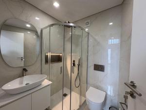 a bathroom with a shower and a sink and a toilet at AlvaLoft Barreiro in Barreiro +17 photos