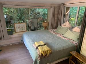 a bedroom with a bed in front of a window at Cabanon in Sanary-sur-Mer