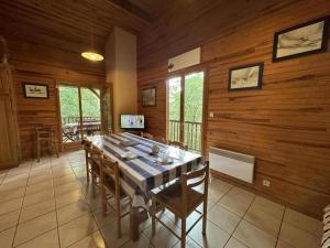 a dining room with a long table and chairs at Chalet des dunes in Biscarrosse