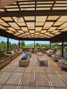 a large outdoor patio with couches and tables at Sun farm souf in Jerash