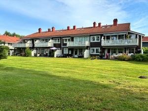 a large house with a large lawn in front of it at Home between flights Gardermoen in Jessheim