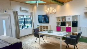 a room with a table and chairs and a bed at Apartment 202 in Bernau bei Berlin