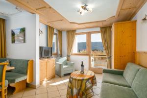 a living room with a couch and a table at Residence Diana Apartment 101 in Terento
