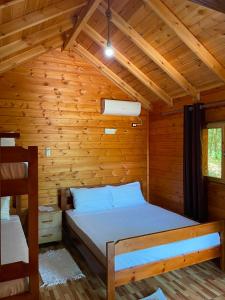 a bedroom with a bed in a wooden cabin at Shija e Natyres in Reç +19 photos