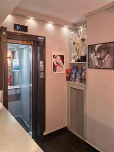 a bathroom with a shower with a glass door at Hotel Schtak in Cannes