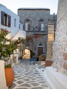 an alley with a stone building with a patio at Elata Stone Retreat Traditional Village House in Chios