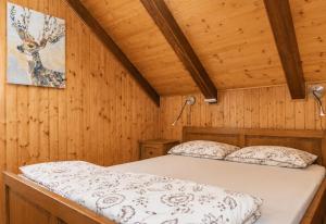 a bedroom with a bed in a wooden room at Kuća za odmor Cozy Bear Cabin in Brestova Draga +42 photos
