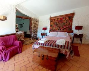 a bedroom with a bed and a chair at Monte Pedras Negras in São Luis