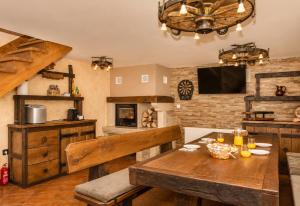 a dining room with a wooden table and a tv at Kuća za odmor Cozy Bear Cabin in Brestova Draga