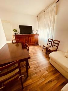 a living room with a table and a couch at A casa di Rita in Udine