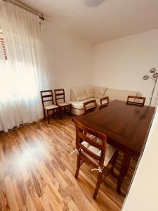 a living room with a table and chairs and a couch at A casa di Rita in Udine