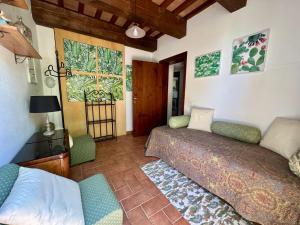 a living room with two beds and a window at Ca' Maggetti in Urbino +48 photos