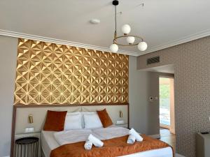 a bedroom with a large bed with towels on it at Annie Villa in Siófok