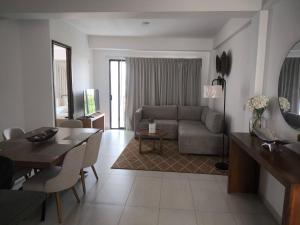 a living room with a couch and a table at Suites Santa Isabella in Ajijic