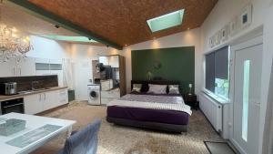 a bedroom with a bed and a table and a kitchen at Apartment 202 in Bernau bei Berlin