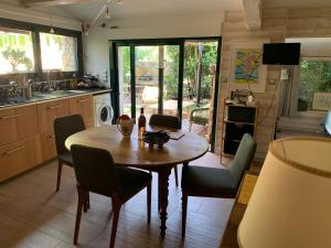 a kitchen with a wooden table and chairs in a kitchen at Cabanon in Sanary-sur-Mer +37 photos