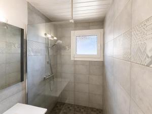 a bathroom with a shower and a toilet and a window at Le Génépi in La Plagne Tarentaise