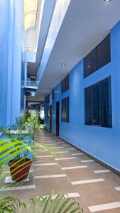 an empty hallway with plants in a building at Hotel Lirios Dorados in Iquitos