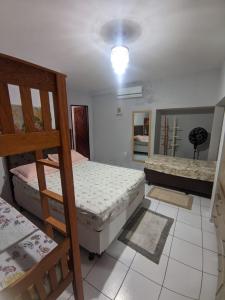 a bedroom with two bunk beds and a mirror at Casarão Em Pirangi Praia - RN in Parnamirim +23 photos
