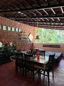 a dining room with a table and chairs and a kitchen at Koppalu Heritage in Vastāra +25 photos