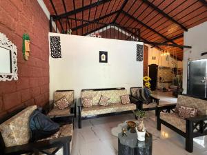 a room with couches and a table and a wall at Koppalu Heritage in Vastāra