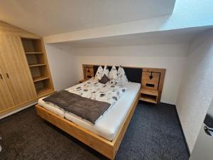 a bedroom with a large bed in a room at Enzian Apartments in Kartitsch