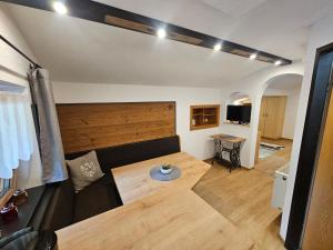 a living room with a couch and a table at Enzian Apartments in Kartitsch