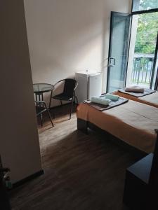 a room with two beds and a table and a chair at TheStarryNight in P'ichvnari
