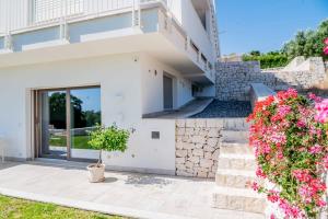 a villa with a view of the garden at Moderno Mediterraneo in Alberobello