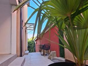 a patio with a chair and a plant next to a building at Apartments Platz in Mostar