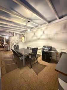 a dining room with a table and chairs and a grill at Reda in Rowy