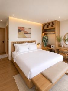 a bedroom with a large white bed and a desk at Vip villa in Phú Quốc +14 photos