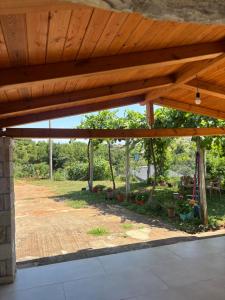 a wooden pergola with a view of a garden at Villa Ndoj Bukmire in Rrëshen
