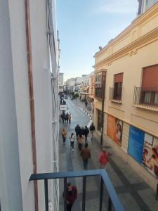 a group of people walking down a street at Ancha 4 en pleno centro in Sanlúcar de Barrameda