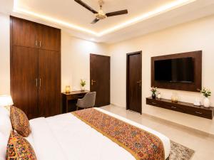 a bedroom with a large bed and a flat screen tv at Hotel RK Plaza - Rukmani vihaar - #Parking #Best Rated Area #Fully Ac #Prem Mandir #Chaar Dhaam in Vrindāvan