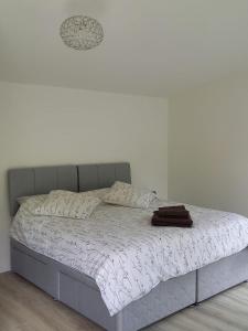 a bed in a room with a white wall at Mount Hillary Holiday Pods in Cork