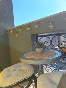 a table with a potted plant on a balcony at Olea relax apartman in Brčko